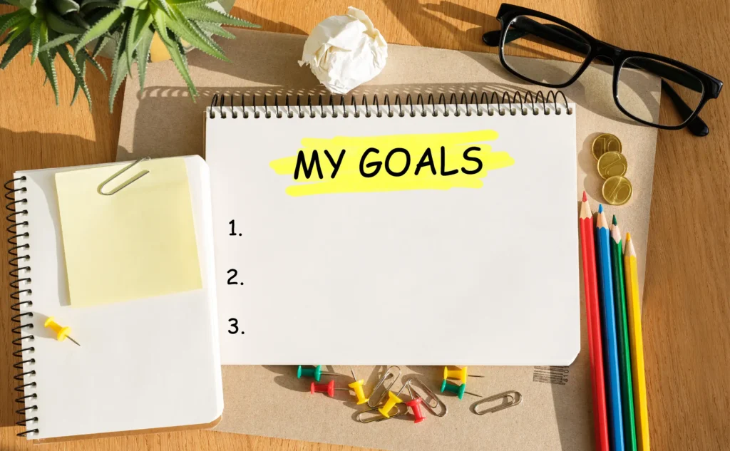 elevation learning - image showing notebooks and pencils with the title 'Goal'